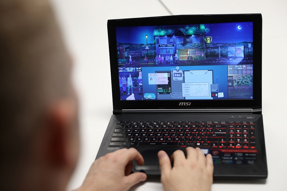 Creative director of the video game, u00e2u20acu02dcNot Tonightu00e2u20acu2122, Tim Constant plays the game on a computer at The Association for UK Interactive Entertainment (UKIE) offices in London August 21, 2018. u00e2u20acu201d AFP pic 