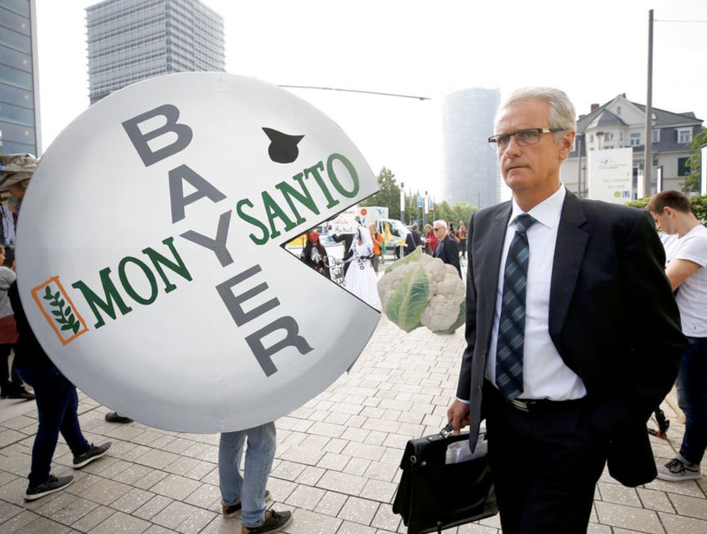 A Bayeru00e2u20acu2122s shareholder arrives at the annual general shareholders meeting as people protest against the merger of Germanyu00e2u20acu2122s pharmaceutical and chemical maker Bayer with Monsanto, in Bonn, Germany, May 25, 2018. u00e2u20acu201d Reuters pic