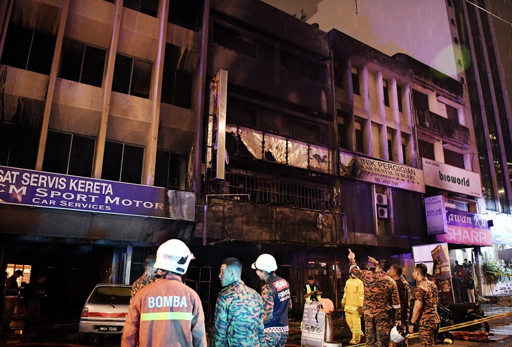 Kuala Lumpur Fire and Rescue Department personnel at the scene of the fire that destroyed a motorcycle shop at Jalan Sentul in Kuala Lumpur July 31, 2018. u00e2u20acu201d Bernama pic