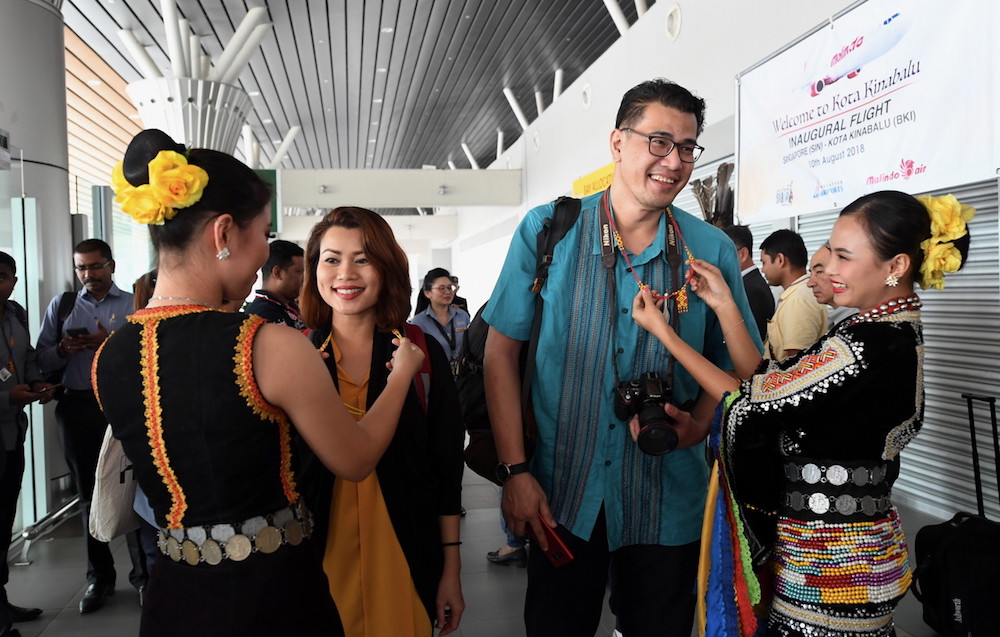 Passengers on the inaugural Kota Kinabalu-Singapore flight are welcomed at Kota Kinabalu International Airport August 10, 2018. u00e2u20acu201d Bernama pic