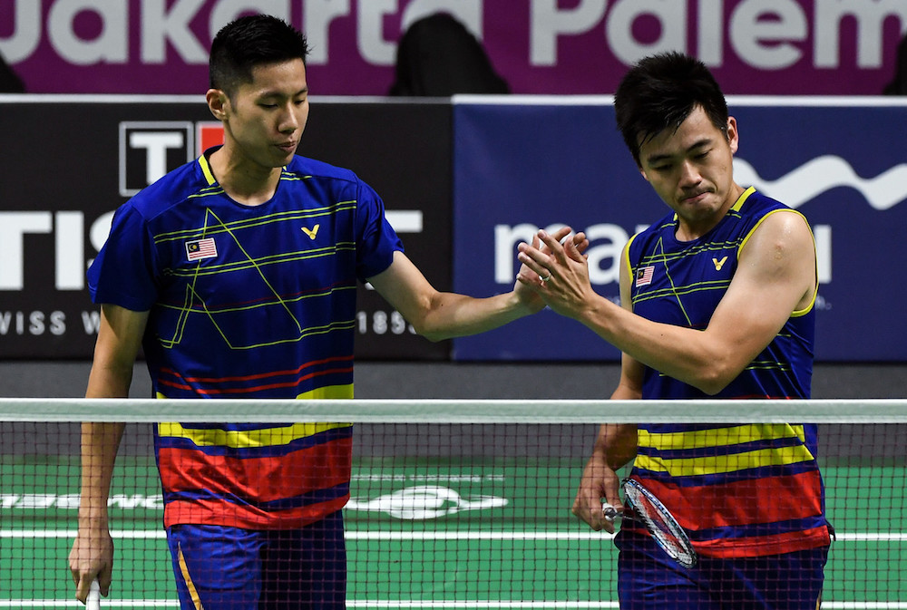 National doubles pair Goh V Shem/Tan Wee Kiong celebrate after defeating Thailandu00e2u20acu2122s Kittinupong Kedren/Dechapol Puavaranukroh in the first round of the individual badminton event at the 2018 Asian Games in Jakarta August 23, 2018. u00e2u20acu201d Bernama pic