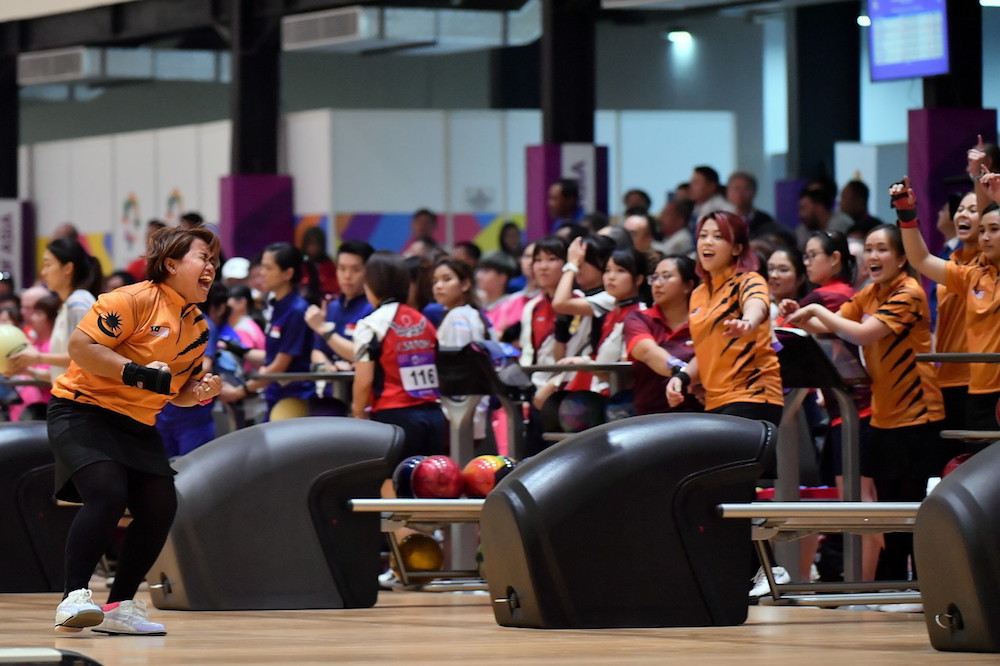 Shalin Zulkifli celebrates with team mates after knocking down all her pins during the womenu00e2u20acu2122s team of six event at the 2018 Asian Games in Palembang August 24, 2018. u00e2u20acu201d Bernama pic