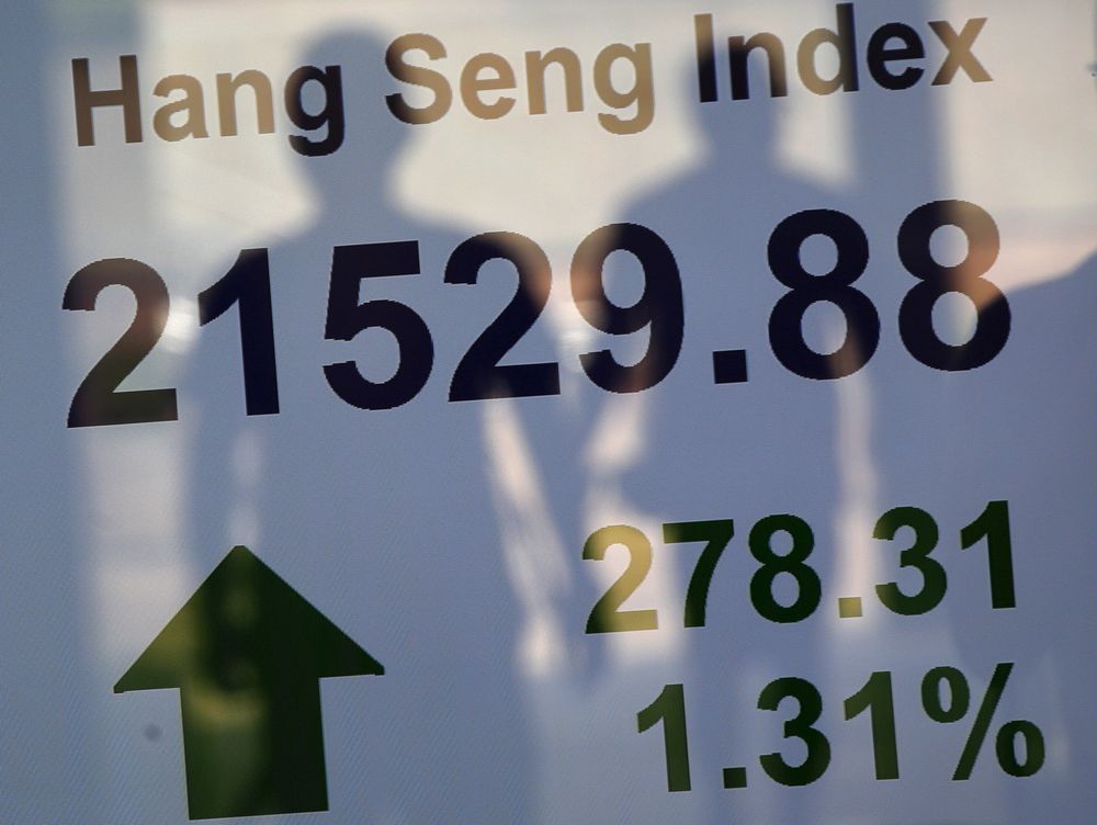 Passers-by are reflected on a panel displaying the Hang Seng Index in Hong Kong, August 25, 2015. u00e2u20acu201d Reuters pic