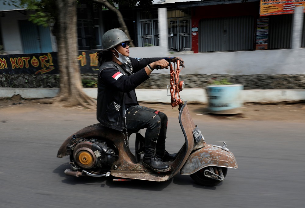 An extreme Vespa enthusiast rides his bike after attending weekend festival for extreme Vespas in Semarang, Central Java, Indonesia July 22, 2018. u00e2u20acu201d Reuters pic