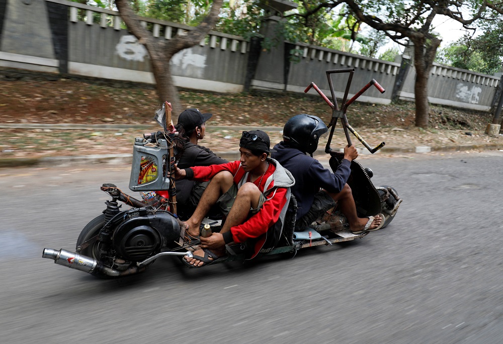 Extreme Vespa enthusiasts ride their bike after attending a weekend festival for extreme Vespas in Semarang, Central Java, Indonesia July 22, 2018. — Reuters pic
