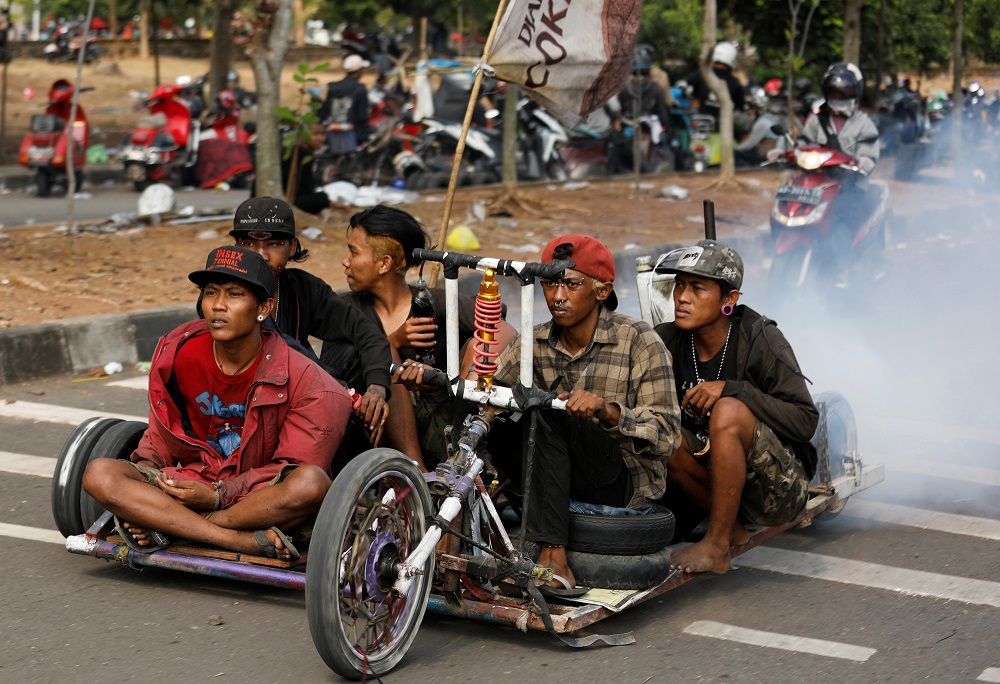 Extreme Vespa enthusiasts drive their bike near the site of a weekend festival for extreme Vespas in Semarang, Central Java, Indonesia July 22, 2018. — Reuters pic