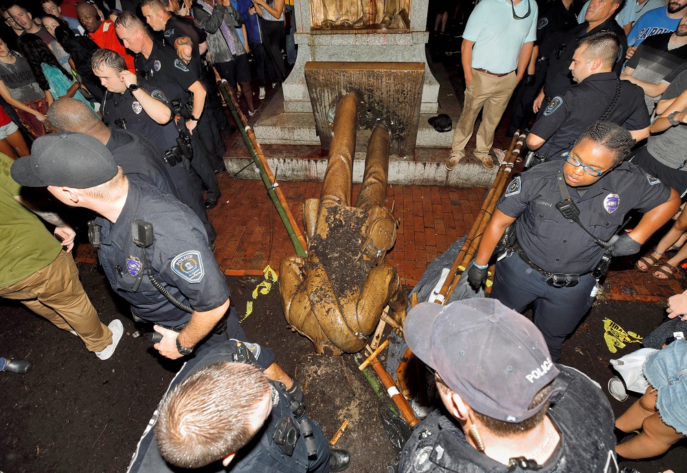 University of North Carolina police surround the toppled statue of a Confederate soldier nicknamed Silent Sam on the school's campus after a demonstration for its removal in Chapel Hill, North Carolina, August 20, 2018. u00e2u20acu201d Reuters pic