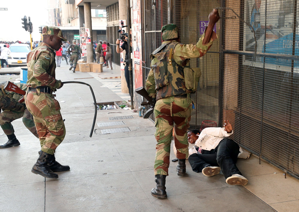 Soldiers beat a supporter of the opposition Movement for Democratic Change party of Nelson Chamisa outside the party's headquarters in Harare, Zimbabwe August 1, 2018. u00e2u20acu201d Reuters pic