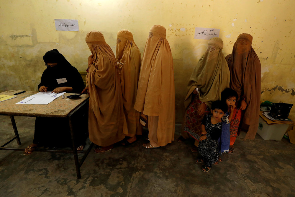 Women, clad in burqas, stand in line to cast their ballot at a polling station during general election in Peshawar, Pakistan July 25, 2018. u00e2u20acu201d Reuters pic