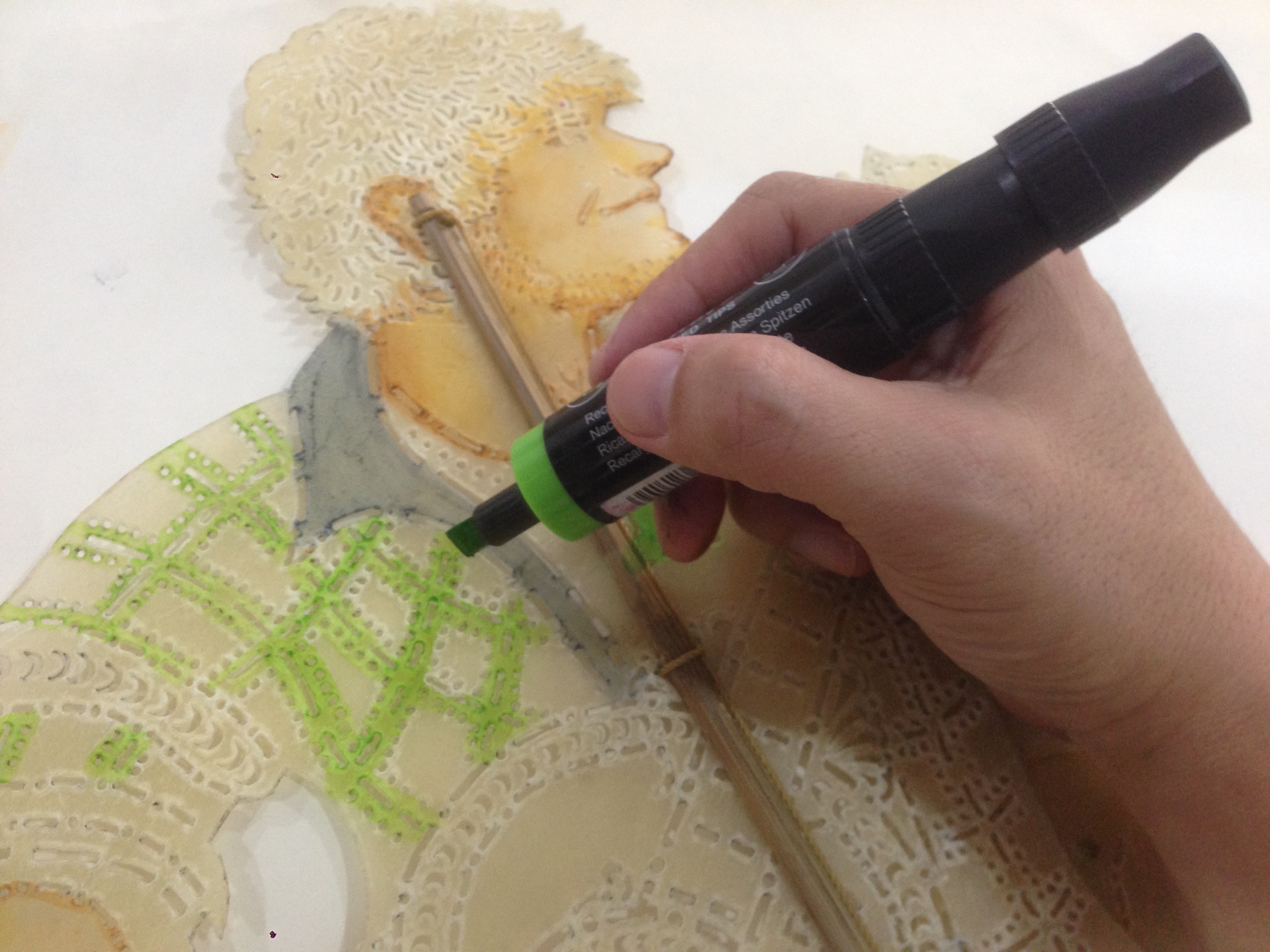 Colouring the puppet, using marker and ink. 
