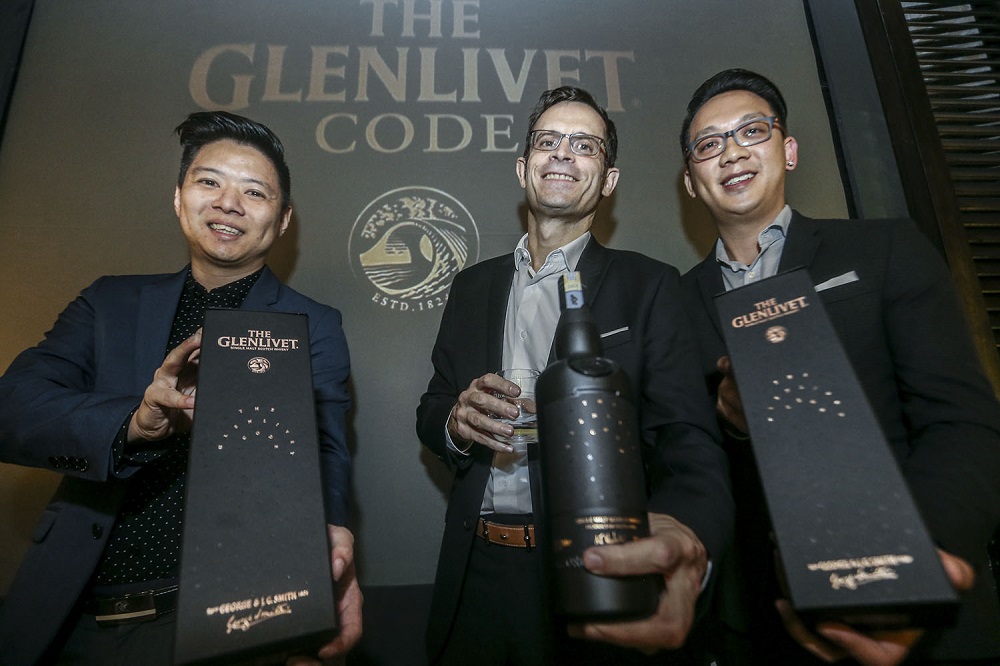 (From left) Pernod Ricard Malaysia senior brand executive Kent Lim (left), marketing director Emmanuel Dokhelar (centre) and brand manager Benedict Yong (right) strikes a pose with The Glenlivet Code. u00e2u20acu201d Picture by Hari Anggara