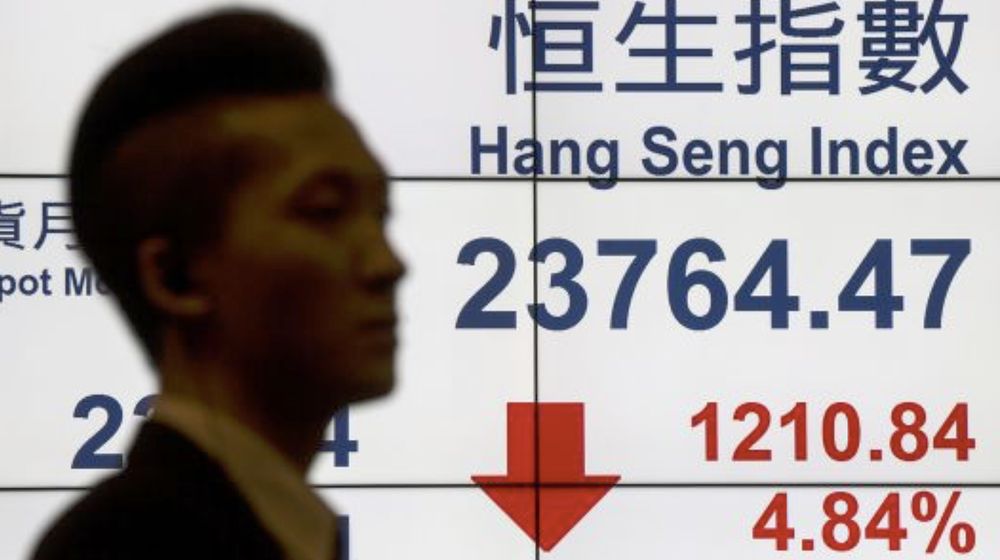 A man walks past a panel displaying the Hang Seng Index at the Hong Kong Exchanges, July 8, 2015. u00e2u20acu201d Reuters pic