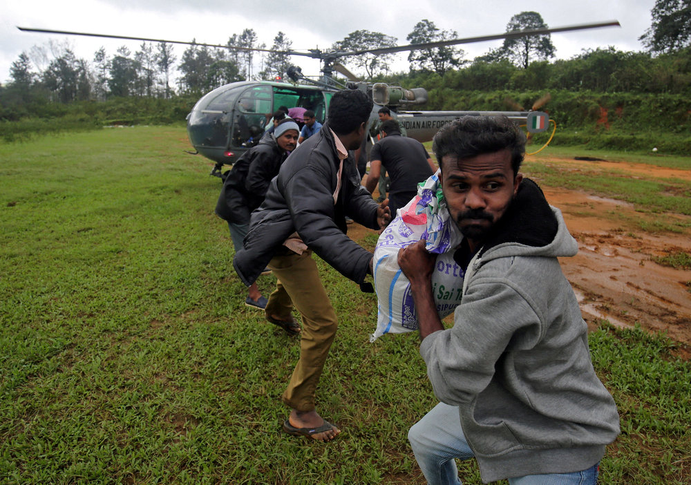 Flood victims unload food and relief material from an Indian Air force helicopter at Nelliyampathy Village, in the southern state of Kerala, India August 21, 2018. u00e2u20acu201d Reuters pic