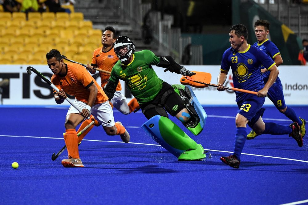 National hockey player Firhan Ashari carried the ball past Kazakhstanu00e2u20acu2122s goalkeeper Yerzhan Yelubayev in the first leg of the 2018Asian Games at Gelora Bung Karno Hockey Stadium in Jakarta, August 20, 2018. Malaysia won 16-2. u00e2u20acu201d Bernama pic