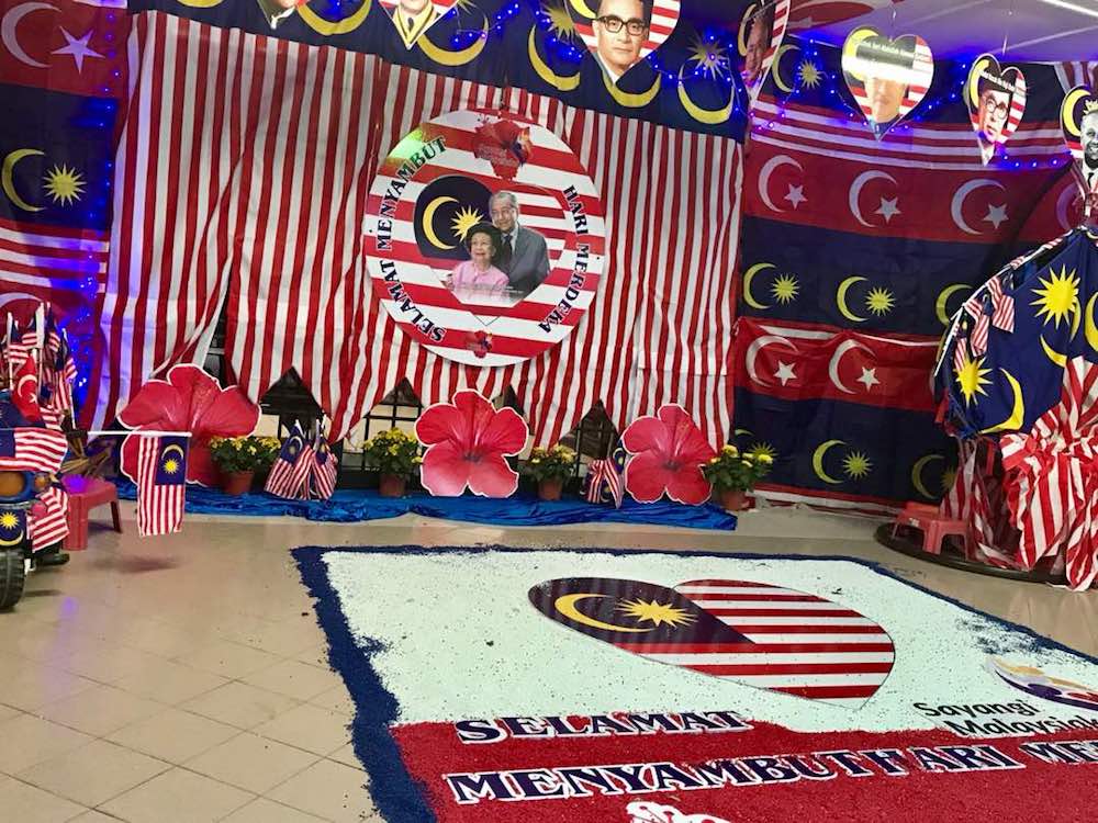 M. Kandapan’s porch has been turned into a large kolam area featuring the Jalur Gemilang and national flower, the hibiscus. — Picture by Ben Tan