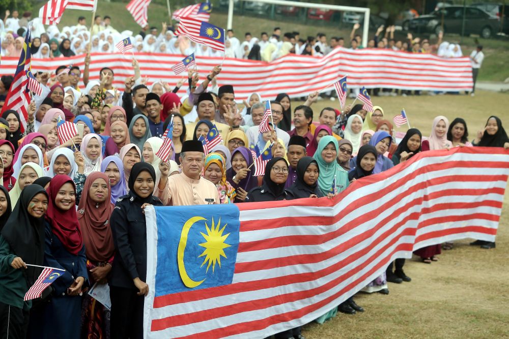 Teachers and students of SMK Kampong Pasir Puteh in Perak created a 52-metre long Jalur Gemilang that will be put up from today until Malaysia Day on September 16 in conjunction with the 61st Merdeka Day celebration. u00e2u20acu2022 Picture by Farhan Najib