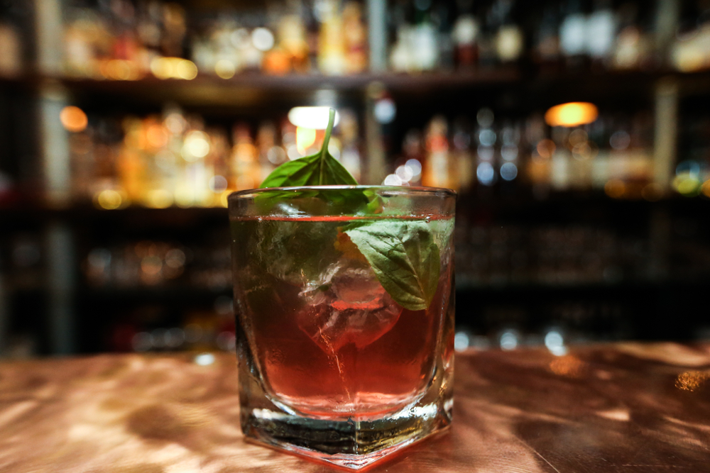 Jin and tonic, topped with basil leaves.