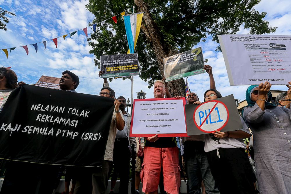 Members of the public hold up placards in protest against the Pan Island link 1 project outside Penang’s State Assembly Building August 10, 2018. — Picture by Sayuti Zainudin