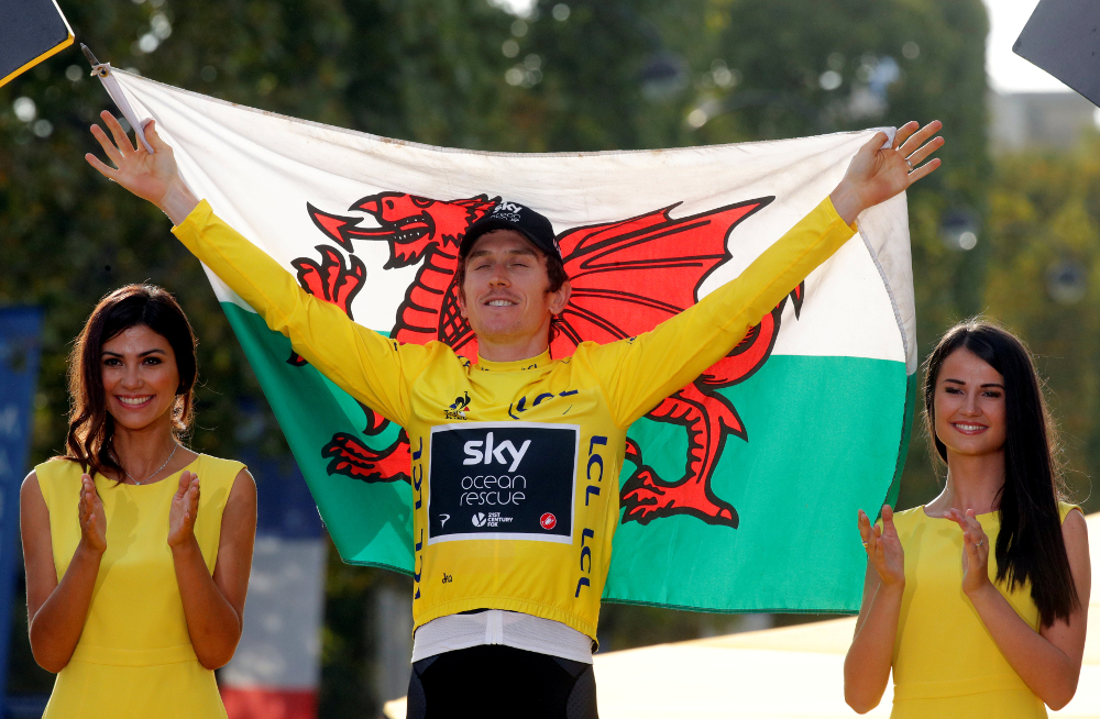 Team Sky rider Geraint Thomas of the UK celebrates his overall victory on the podium with a Welsh flag after winning the Tour de France in Paris July 29, 2018. u00e2u20acu201d Reuters pic