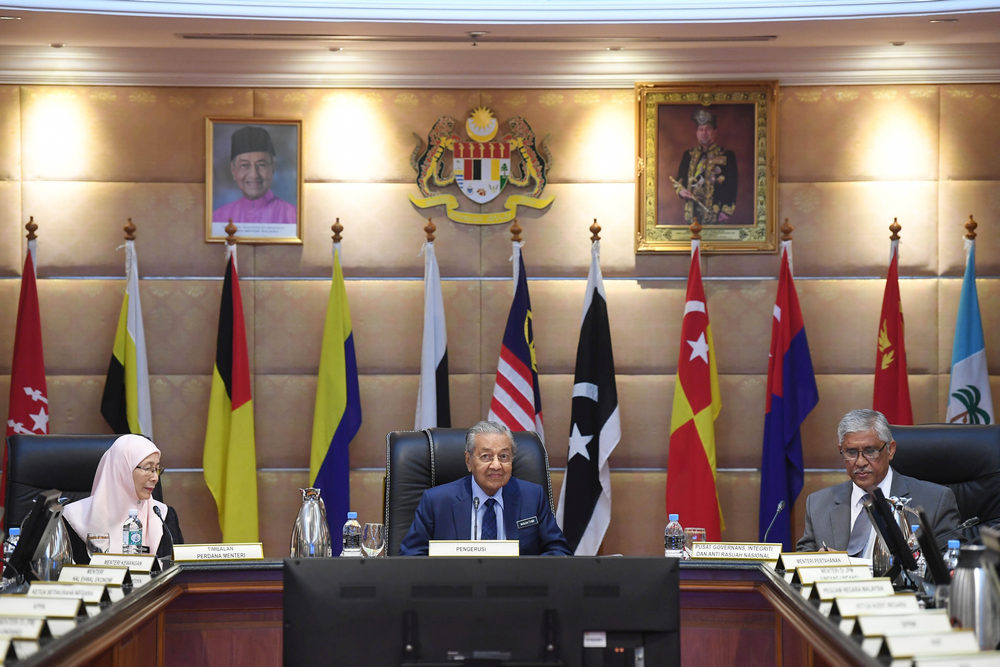 Prime Minister Tun Mahathir (centre)  and Deputy Prime Minister Datuk Seri Wan Azilah Wan Ismail ((left) at a special cabinet meeting in Putrajaya August 13, 2108. u00e2u20acu201d Picture by Azinuddin Ghazali.