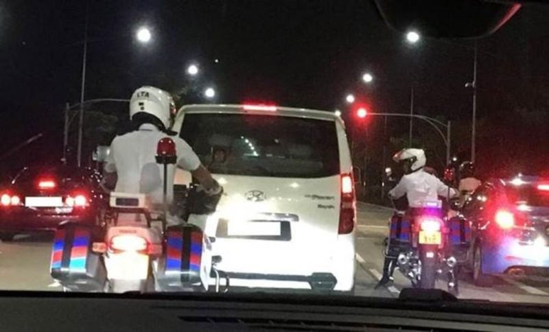 LTA Enforcement Officers stopping a Malaysia-registered vehicle suspected of providing illegal transport service in Singapore. u00e2u20acu2022 TODAY pic