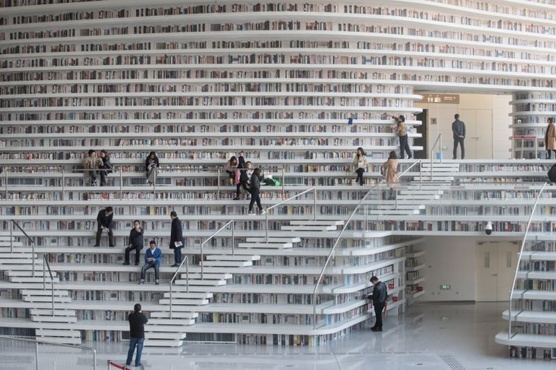 This picture taken on November 14, 2017 shows people visiting the Tianjin Binhai Library, a futuristic Chinese library. u00e2u20acu2022 AFP pic