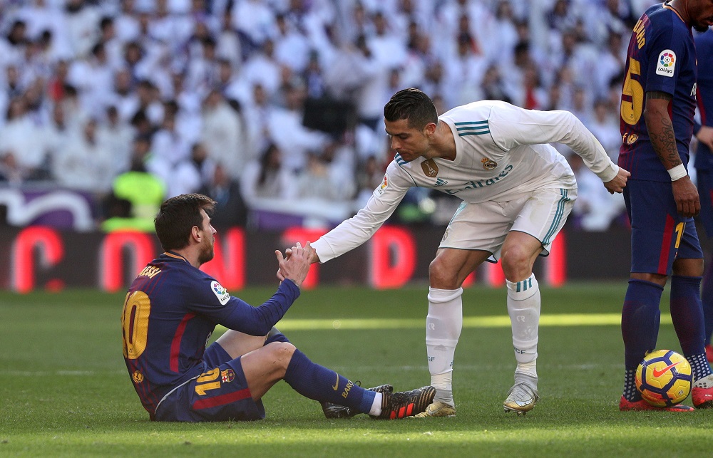 Real Madridu00e2u20acu2122s Cristiano Ronaldo helps Barcelonau00e2u20acu2122s Lionel Messi get back to his feet during a match at Santiago Benabeu stadium in Madrid December 23, 2017. u00e2u20acu201d Reuters pic