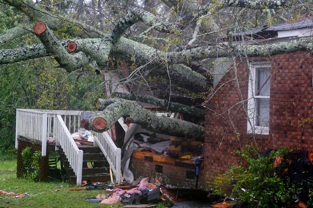 A house where, according to local media, a woman and her child died as a result of a downed tree is pictured as Hurricane Florence comes ashore in Wilmington, North Carolina September 14, 2018. u00e2u20acu201d Reuters pic