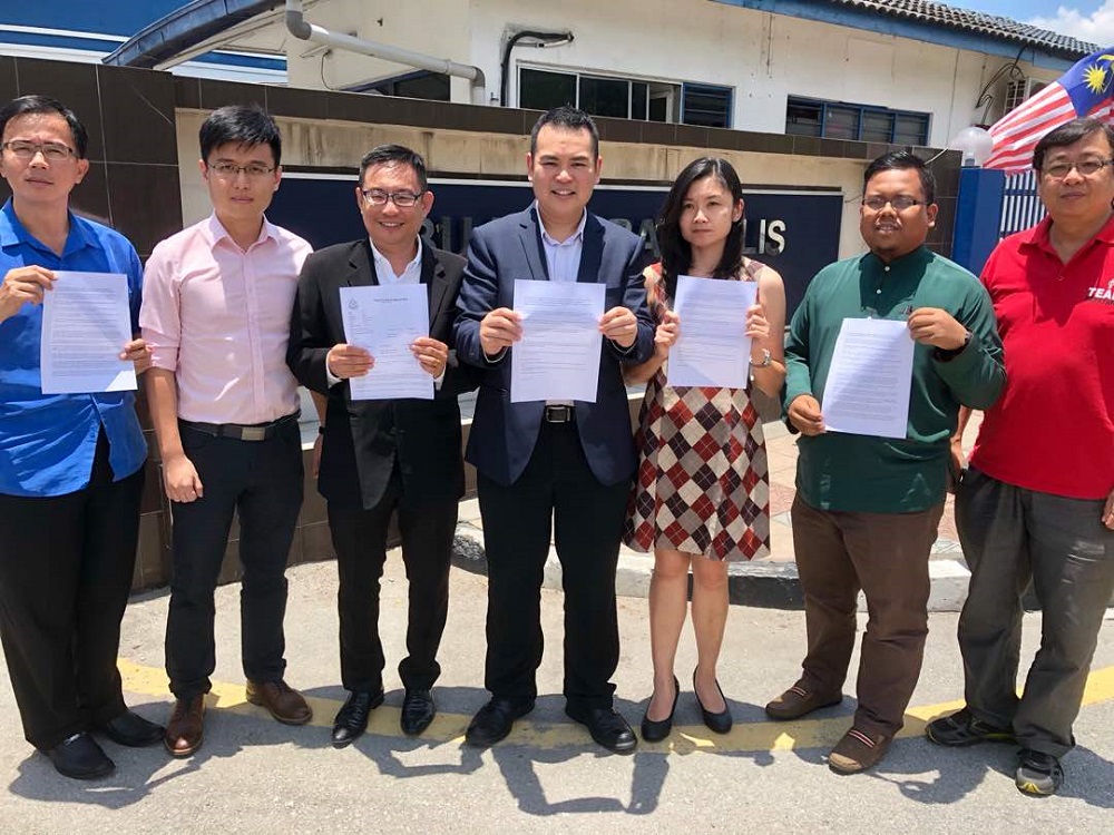 Keranji assemblyman Chong Zhemin (fourth left) lodged a police report against Datuk Seri Tajuddin Abdul Rahman at the Ipoh police district headquarters September 3, 2018. u00e2u20acu201d Picture by Marcus Pheong