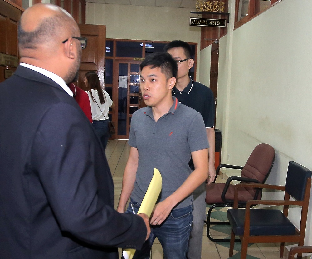 Yap Ying Chao (back, partially visible) and Boo Weil Seng (centre) claimed trial at the Sessions court for fraud, in Ipoh September 7, 2018. u00e2u20acu201d Picture by Farhan Najib