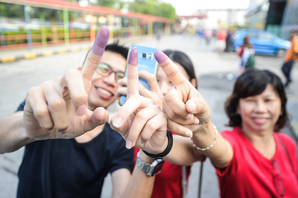 People show their ink-stained fingers after casting their ballots during the Balakong by-election at SJK(C) Batu 11 Cheras in Kuala Lumpur September 8, 2018. u00e2u20acu201d Picture by Shafwan Zaidon