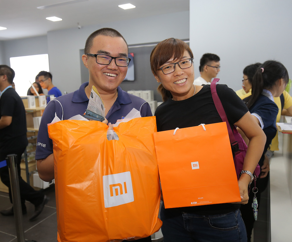 Ong Chee Keat and Tan Chia Li were among the first customers to step inside the first Mi Store in Ipoh Parade. — Picture by Marcus Pheong