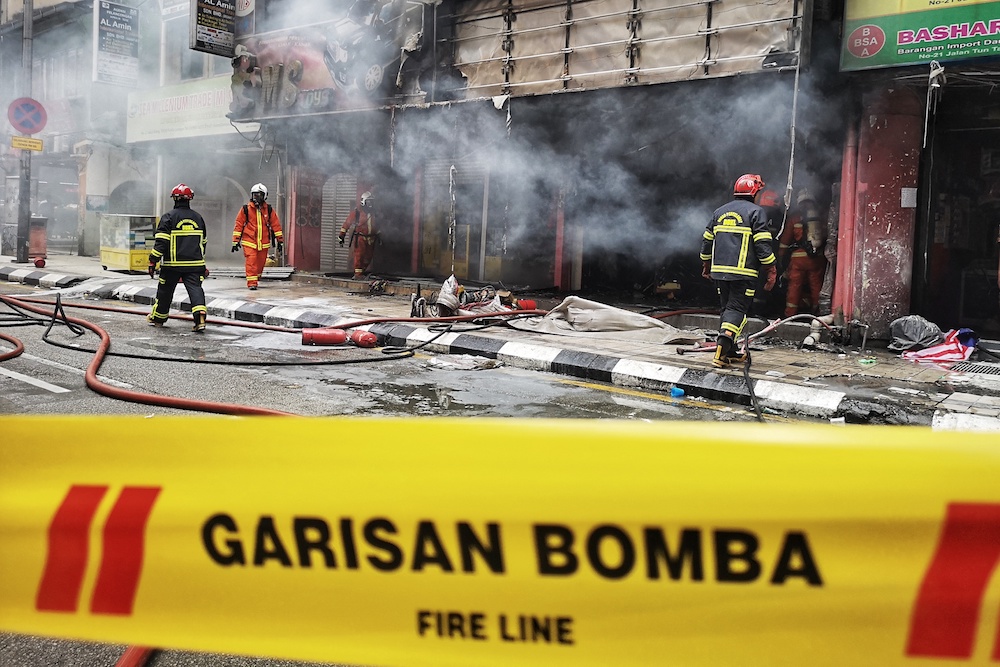 Fire and Rescue Department personnel extinguish a fire at Wisma Malik on Jalan Tun Tan Siew Sin, Kuala Lumpur September 14, 2018. u00e2u20acu201d Picture by Shafwan Zaidon