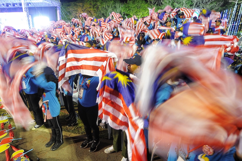 Participants wave flags during 2018 Malaysia Day Celebrations at Padang Merdeka in Kota Kinabalu September 16, 2018. u00e2u20acu201d Picture by Shafwan Zaidon