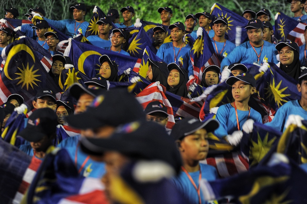 Participants wave flags during 2018 Malaysia Day Celebrations at Padang Merdeka in Kota Kinabalu September 16, 2018. u00e2u20acu201d Picture by Shafwan Zaidon