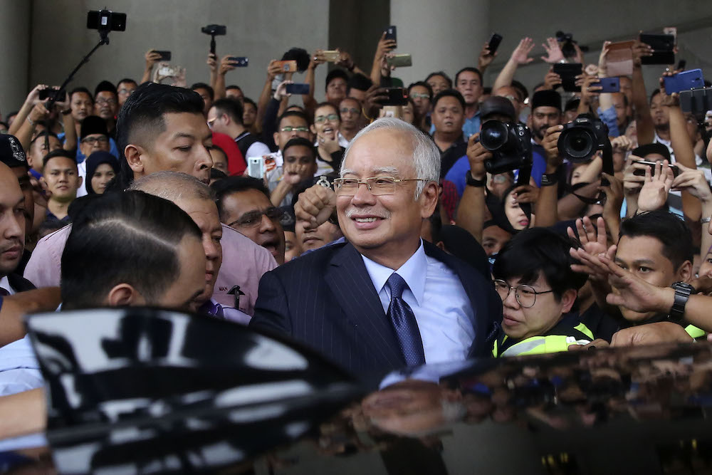 Former prime minister Datuk Seri Najib Razak smiles as he leaves the Kuala Lumpur Court Complex September 20, 2018. u00e2u20acu201d Picture by Yusof Mat Isa