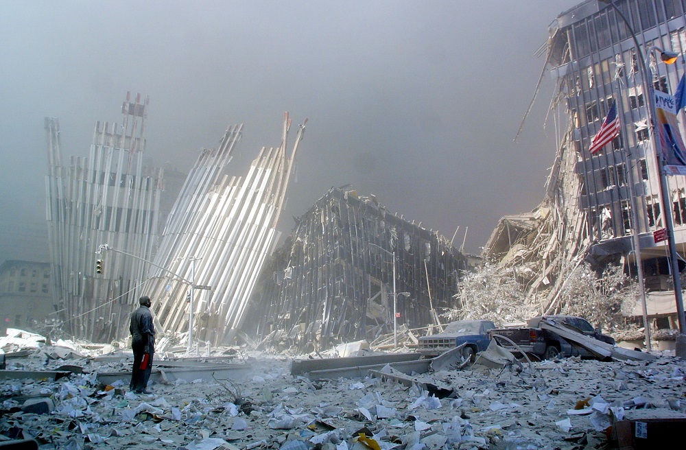 In this file photo taken on September 11, 2001, a man stands in the rubble, and calls out asking if anyone needs help, after the collapse of the first World Trade Centre Tower in New York. u00e2u20acu201d AFP pic 