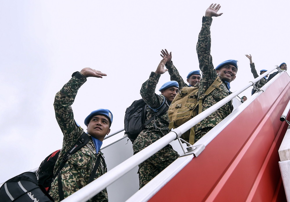 Members of Malbatt 850-6 wave as they board their flight for Lebanon at the Royal Air Force base in Subang September 6, 2018. u00e2u20acu201d Bernama pic