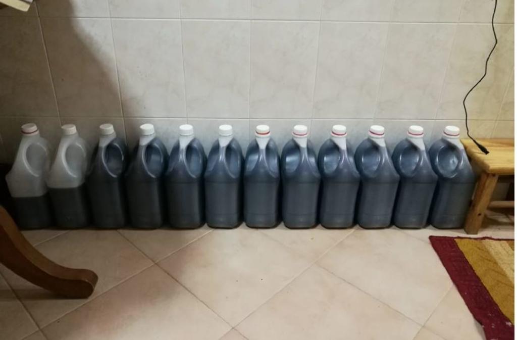 Stocks of the illegal cough syrup in large containers seized from the HDB flat. u00e2u20acu201d Picture courtesy of Health Sciences Authority Singapore