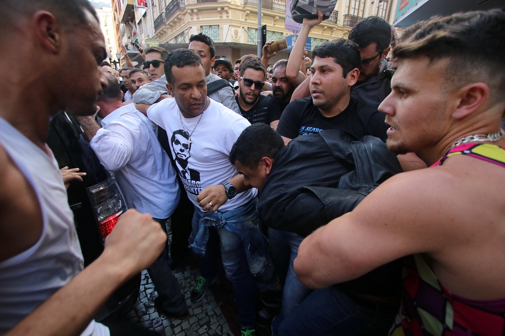 People surround a man suspected of stabbing Brazilian presidential candidate Jair Bolsonaro (not pictured) as he was campaigning in Juiz de Fora, Minas Gerais state, Brazil September 6, 2018. u00e2u20acu201d Reuters  pic