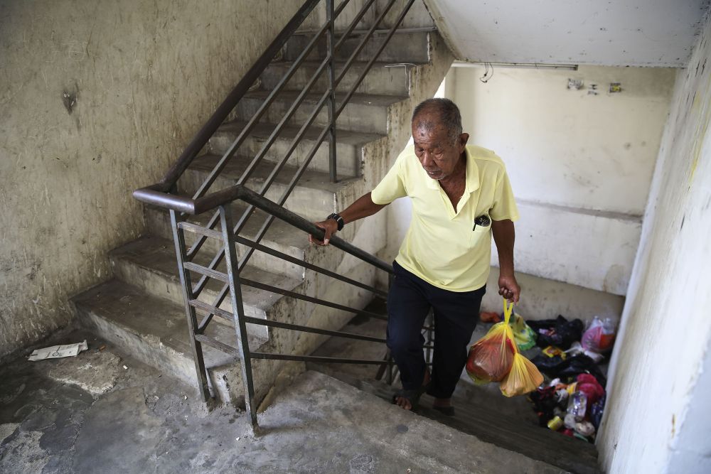Yap Ping Chai, a resident of the Mutiara Fadason flats, has had to walk all the way up to the 16th floor after the elevators malfunctioned last month. u00e2u20acu201d Picture by Yusof Mat Isa
