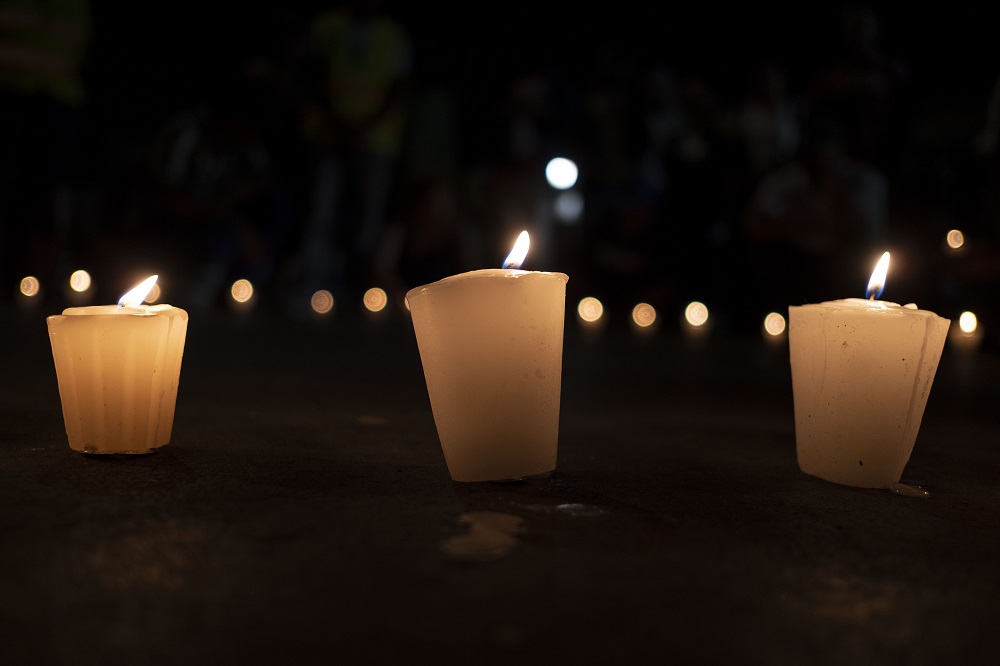 This photo shows candles lit by members of the Pueblos Sin Fronteras during a vigil to raise awareness of local police harassment and abuse of migrants, deported migrants and homeless in Tijuana, Baja California state, on September 16, 2018. u00e2u20acu201d AFP pic