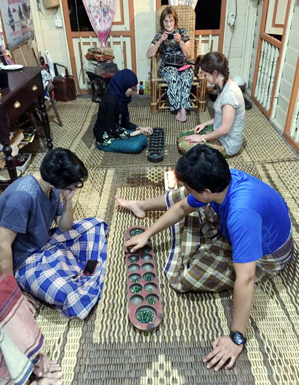 Visitors to Suka-Suka Lake Retreat play Malay traditional games such as ‘congkak’. — Picture courtesy of SukaSuka Lake Retreat