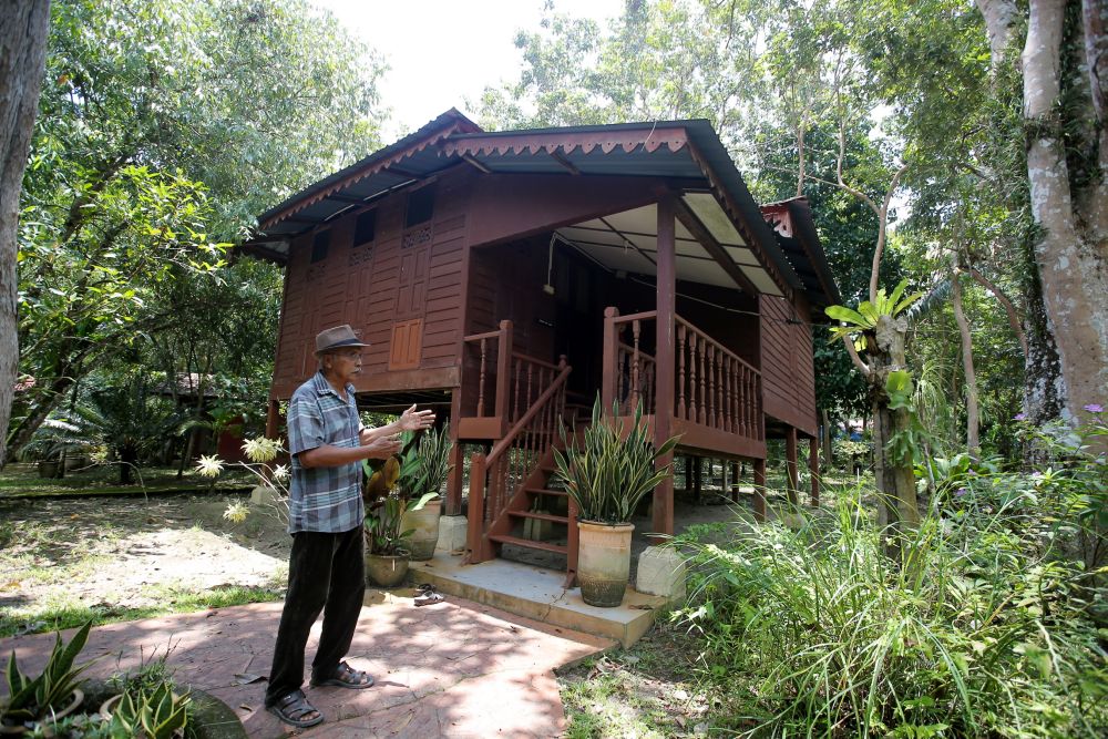Owner of Suka-Suka Lake Retreat, Aziz Manaf, 68, shows the traditional-style chalets on offer at the resort.