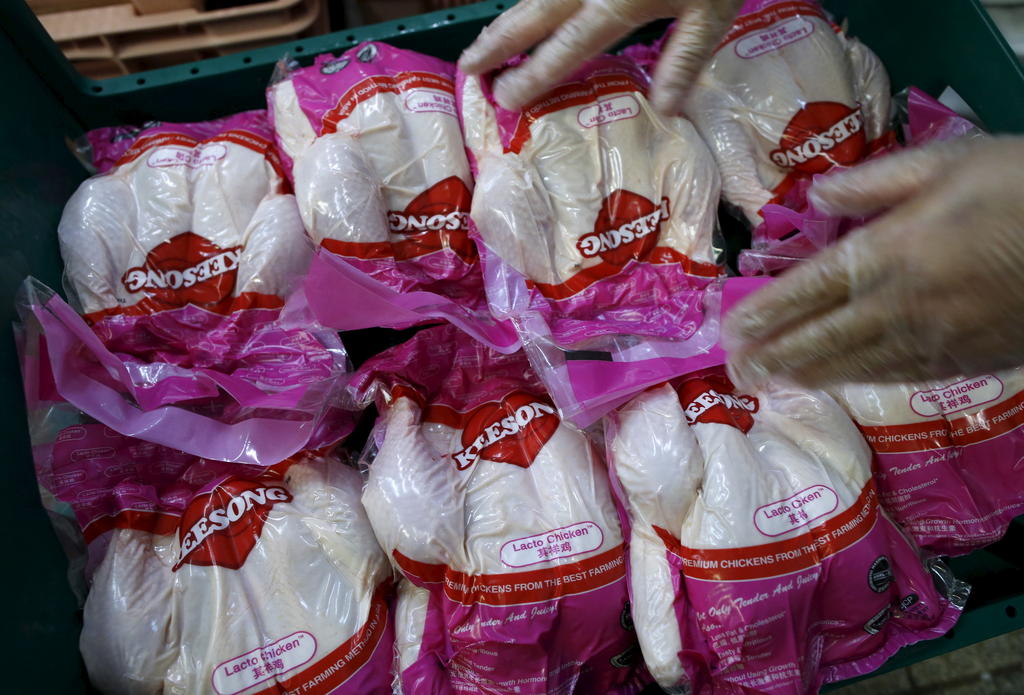 A worker arranges vacuum-packed chickens to be blast frozen at Kee Song Food Corporation's poultry slaughterhouse. u00e2u20acu201d Reuters pic