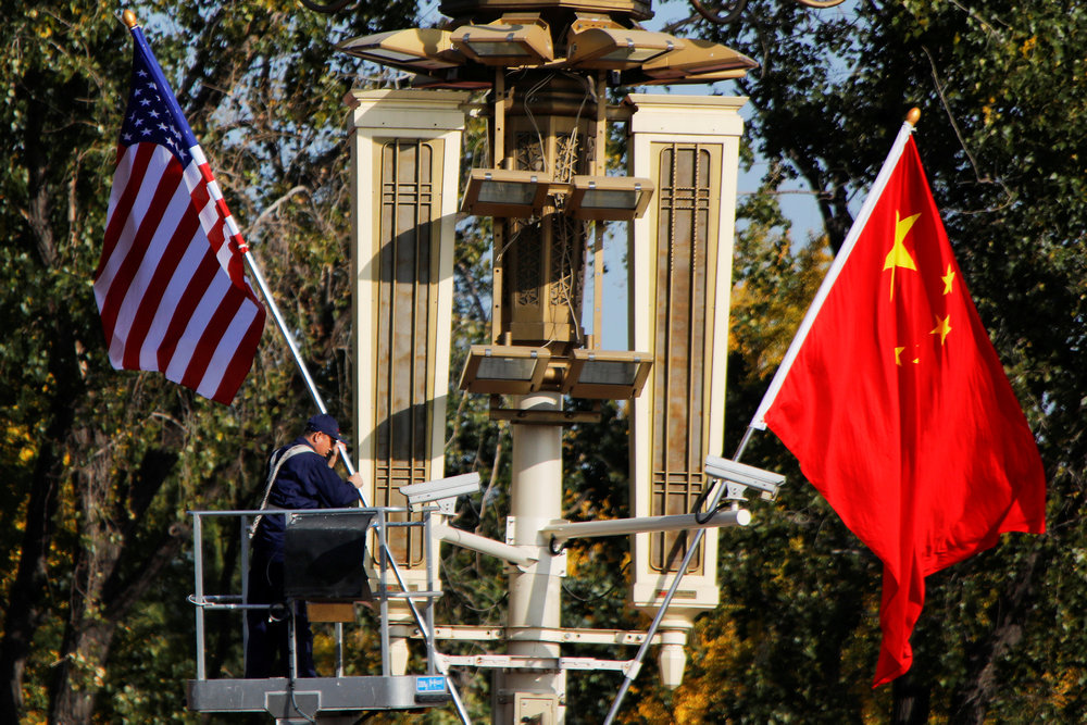 A worker places US and China flags near the Forbidden City ahead of a visit by US President Donald Trump to Beijing November 8, 2017. u00e2u20acu201d Reuters pic