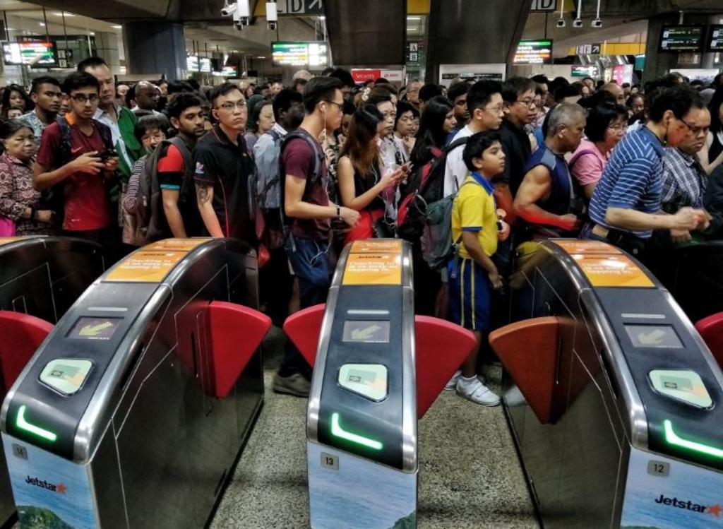 Commuters at Jurong East MRT station this morning. Train services had to be stopped between Clementi and Jurong East stations to allow SMRT staff to check on the track point fault. u00e2u20acu201d Twitter/Brian Teo