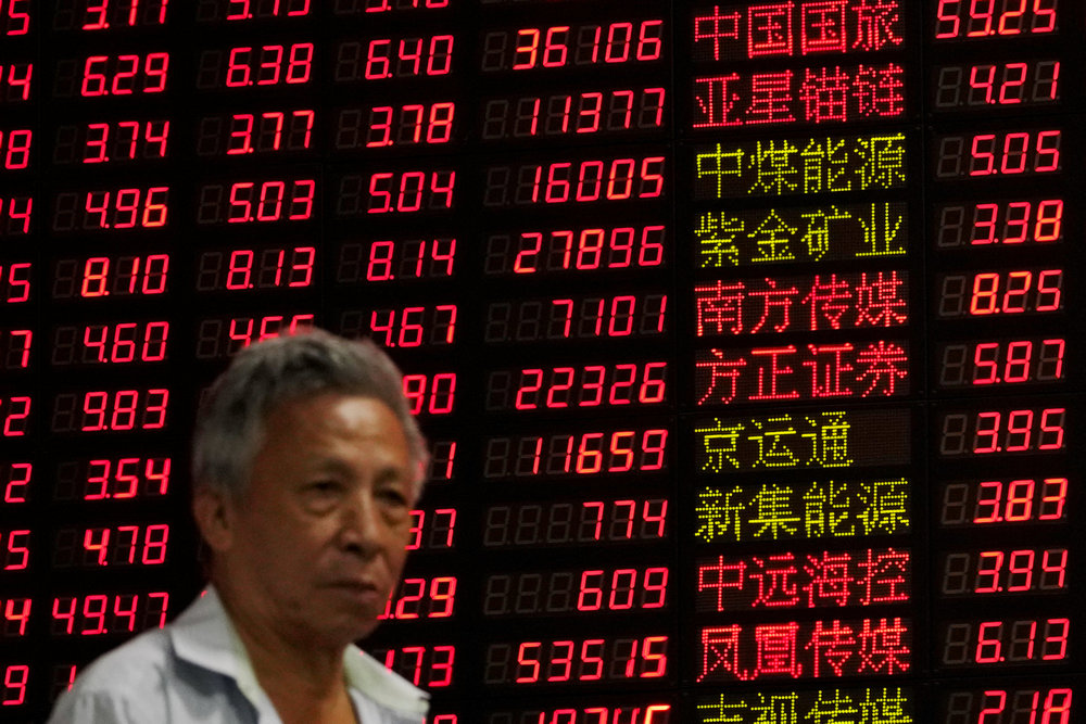 An investor stands in front of an electronic board showing stock information at a brokerage house in Shanghai September 7, 2018. u00e2u20acu201d Reuters pic