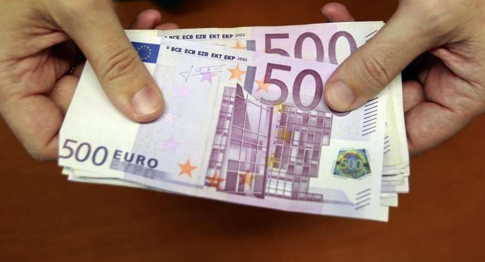 A bank employee holds a pile of 500 euro notes at a bank branch in Madrid January 13, 2011. u00e2u20acu201d Reuters pic