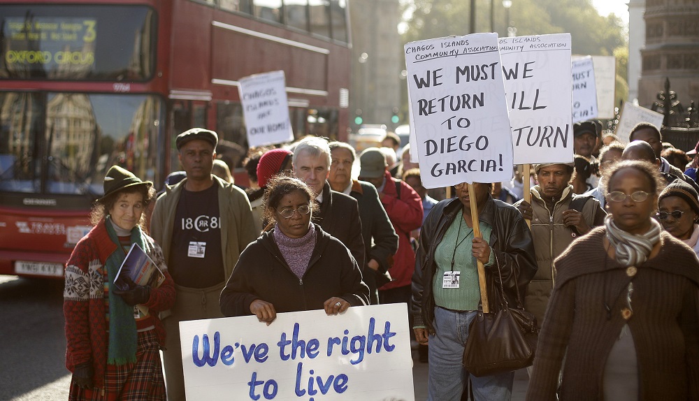 In this file photo taken on October 22, 2008 Chagos Islanders hold placards reading 'we must return to Diego Garcia' and 'we've right to live', during a demonstration outside the London's Houses of Parliament. u00e2u20acu201d AFP pic